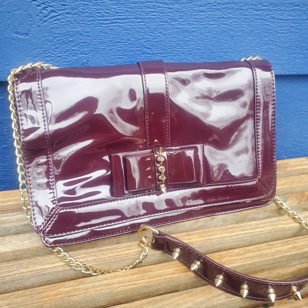 Patent leather burgundy studded crossbody with animal print interior